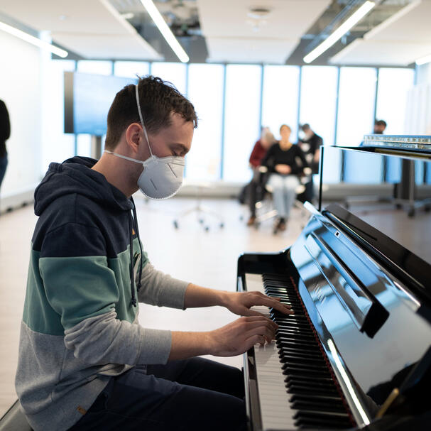 Me playing piano while wearing a surgical mask.